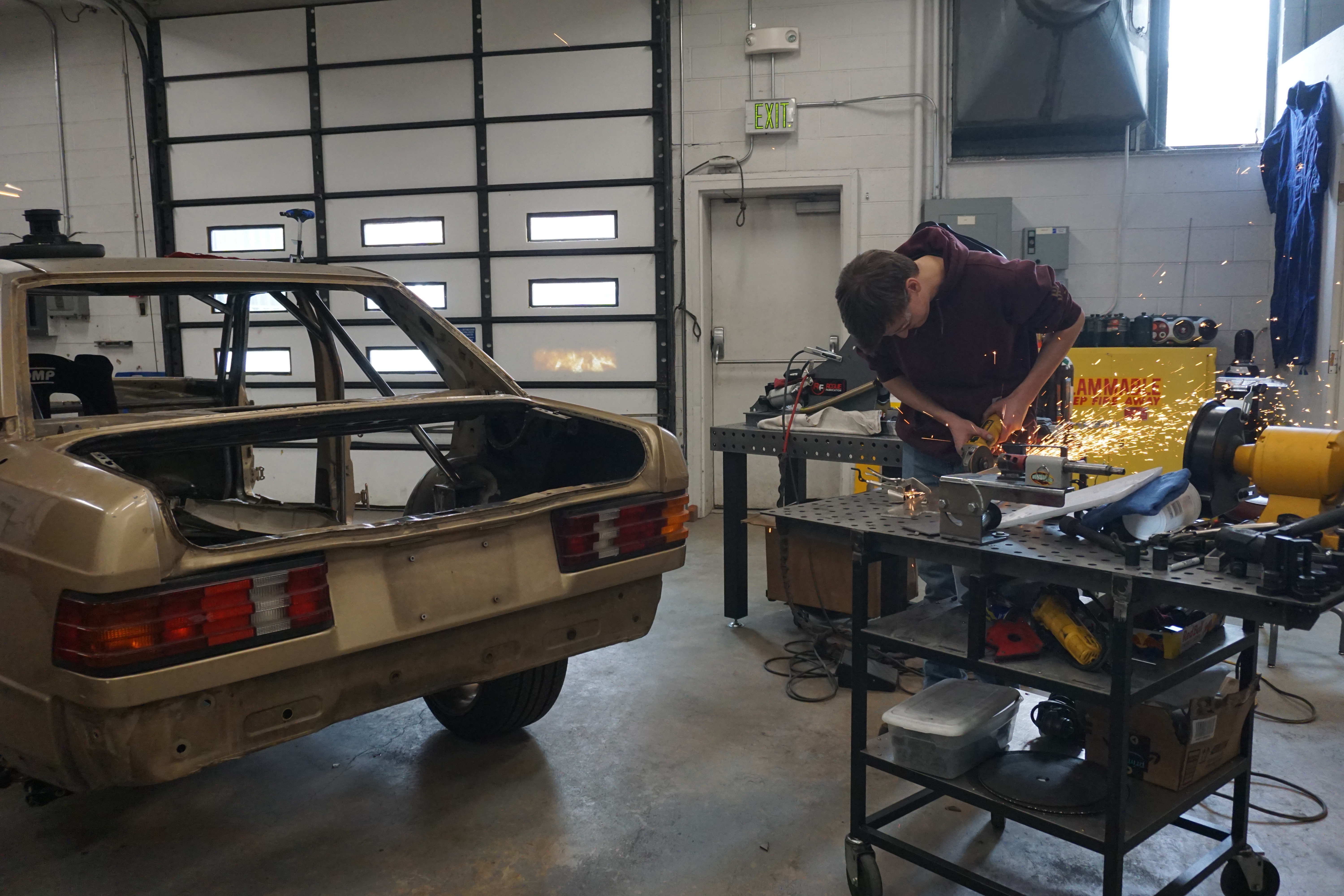 Fourth-year student Jackson Bolinger works on parts for the Mercedes 190 that Time Attack hopes to race at Pikes Peak.