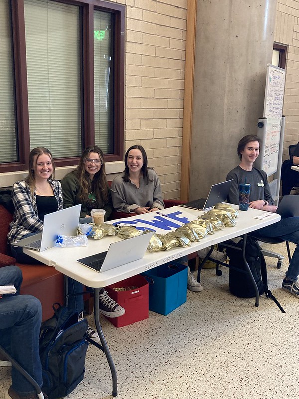 University of Denver Ritchie School students with swag and merchandise ready to chat with other students.