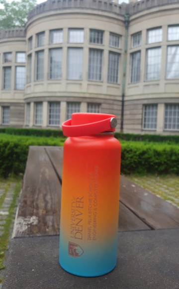University of Denver colorful water bottle in front of an old building for study abroad.