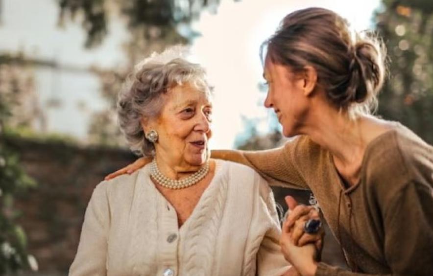 two women talking and smiling