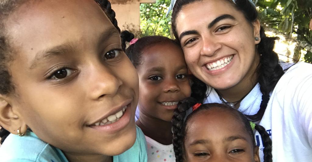 Oli Hassan with children in the Dominican Republic