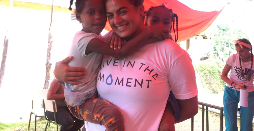 Oli Hassan with children in the Dominican Republic